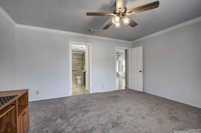 unfurnished bedroom featuring visible vents, light colored carpet, a textured ceiling, and crown molding