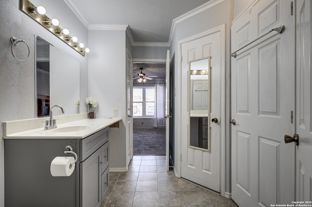 bathroom featuring tile patterned flooring, ceiling fan, baseboards, ornamental molding, and vanity