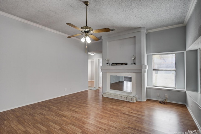 unfurnished living room with a glass covered fireplace, wood finished floors, and ornamental molding