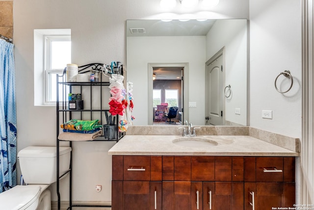 full bath featuring visible vents, toilet, and vanity