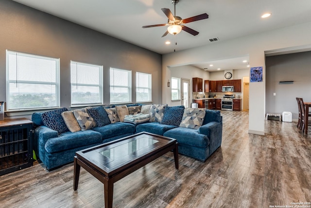 living area featuring visible vents, recessed lighting, ceiling fan, and wood finished floors