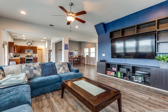 living area with recessed lighting, wood finished floors, visible vents, and ceiling fan