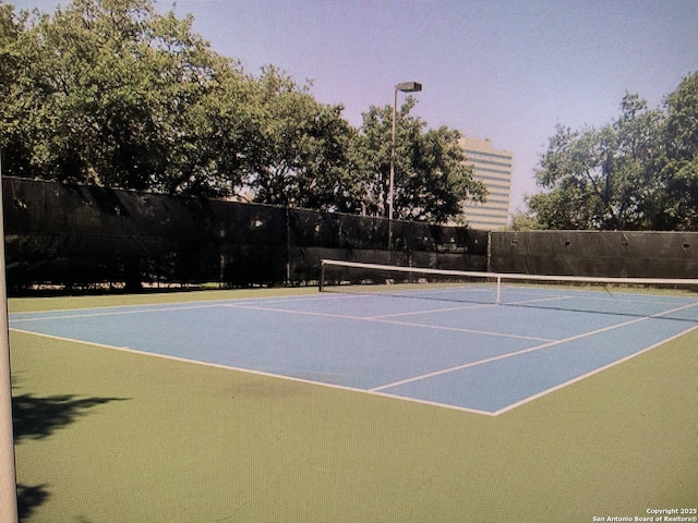 view of sport court with fence