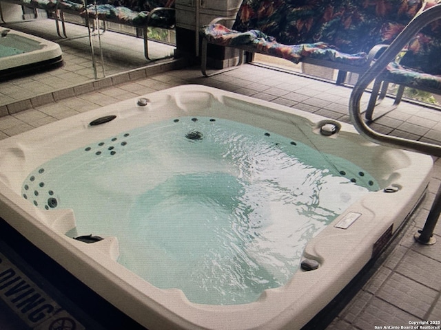 view of swimming pool with a patio and hot tub deck surround