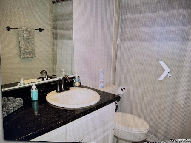 bathroom featuring toilet and vanity