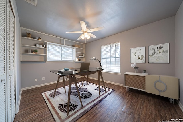 office area with a ceiling fan, visible vents, wood finished floors, and baseboards