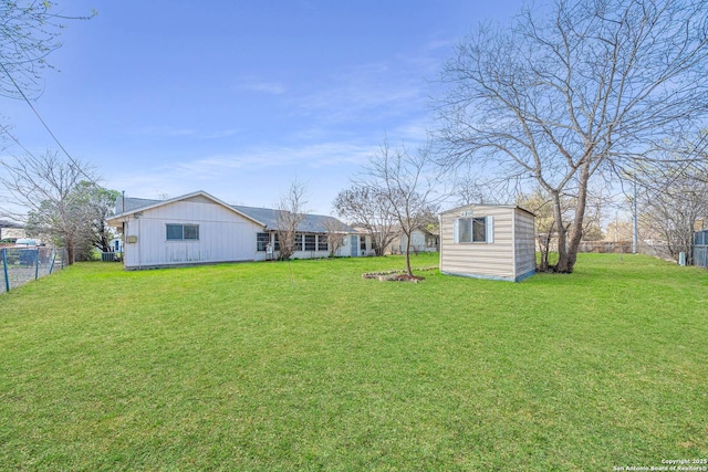 view of yard with an outdoor structure and fence