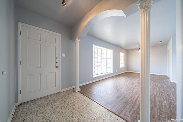 entrance foyer with wood finished floors, arched walkways, decorative columns, baseboards, and ceiling fan