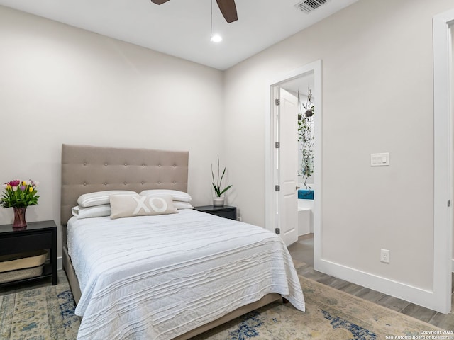 bedroom featuring visible vents, ensuite bathroom, wood finished floors, recessed lighting, and baseboards