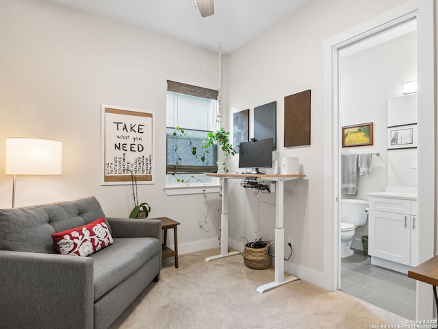 interior space with light carpet, baseboards, and a ceiling fan