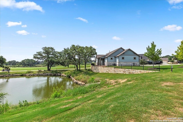 view of yard featuring a water view and fence