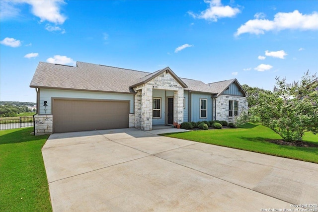 view of front of property with a garage, stone siding, board and batten siding, and a front yard