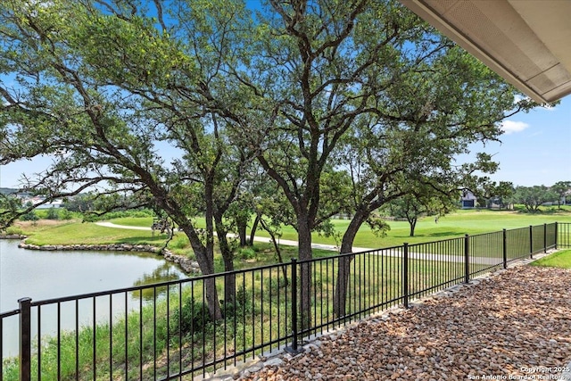 view of property's community featuring a water view and fence