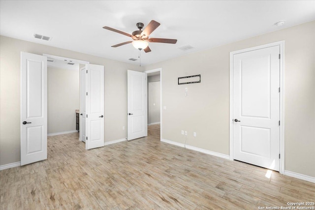 unfurnished bedroom featuring visible vents, a ceiling fan, light wood-type flooring, and baseboards