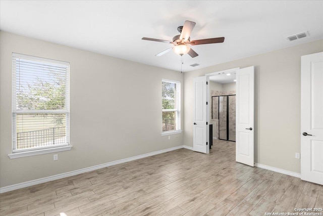 unfurnished bedroom featuring visible vents, light wood-style flooring, a ceiling fan, and baseboards