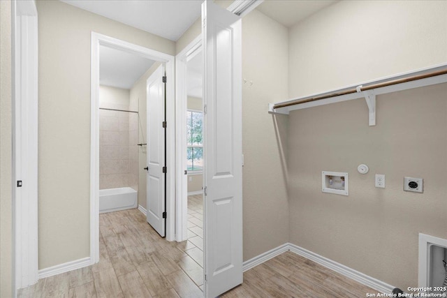 washroom with hookup for an electric dryer, laundry area, washer hookup, light wood-style floors, and hookup for a gas dryer