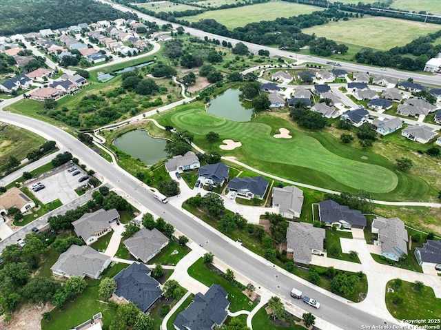 aerial view featuring golf course view, a residential view, and a water view