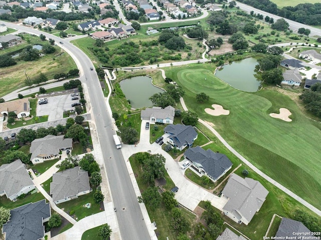 birds eye view of property with a residential view, golf course view, and a water view