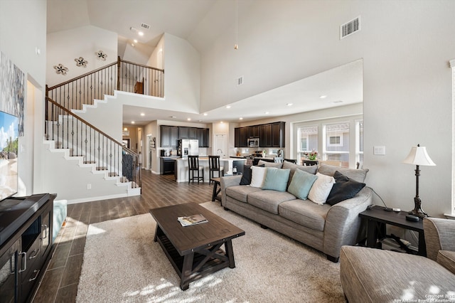 living area with visible vents, baseboards, wood tiled floor, stairs, and recessed lighting