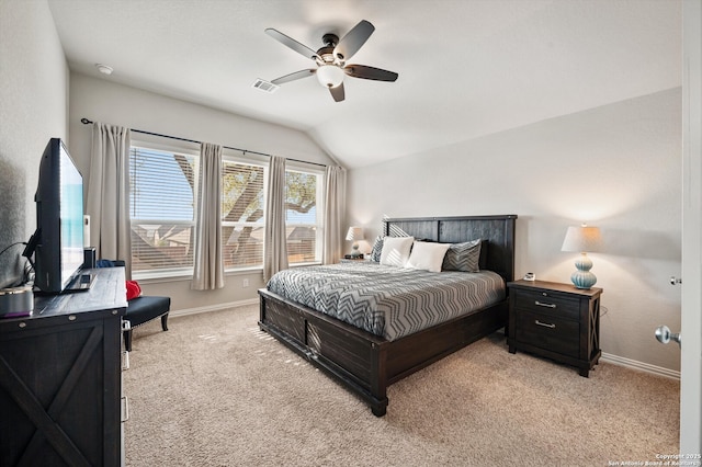 bedroom with light carpet, ceiling fan, baseboards, and vaulted ceiling