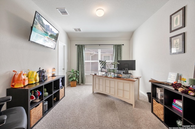 home office with visible vents, baseboards, carpet, and vaulted ceiling