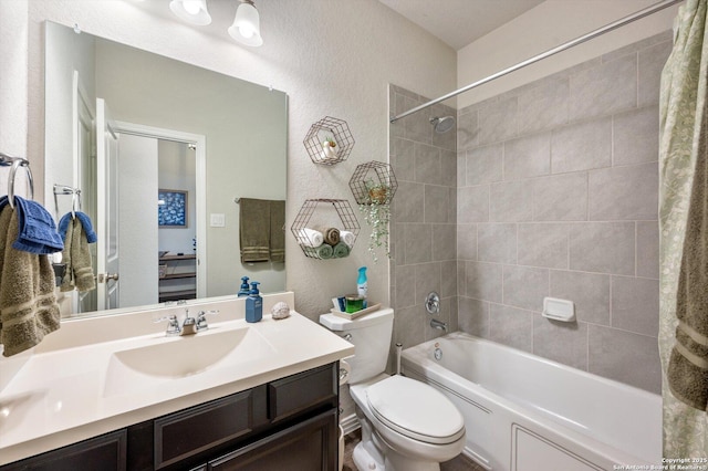 bathroom featuring vanity, toilet, shower / tub combo with curtain, and a textured wall