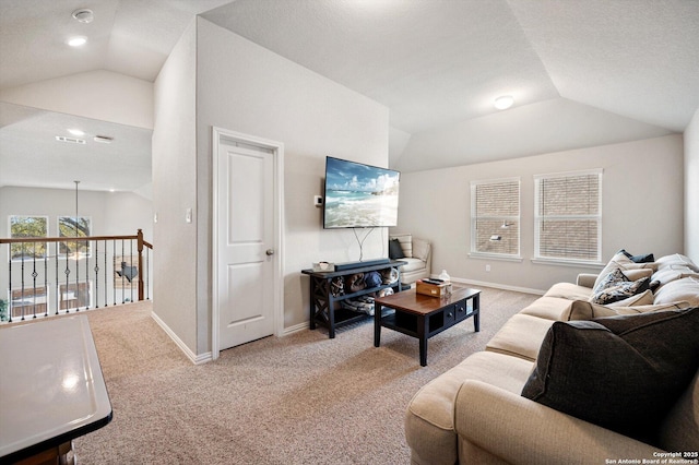 living area featuring carpet flooring, visible vents, baseboards, and lofted ceiling