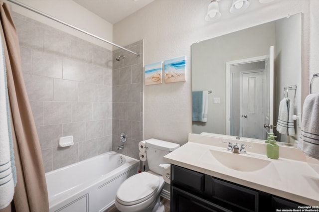 full bathroom featuring vanity, shower / bath combination with curtain, and toilet