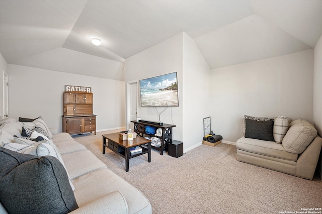 living area with baseboards, light carpet, and vaulted ceiling