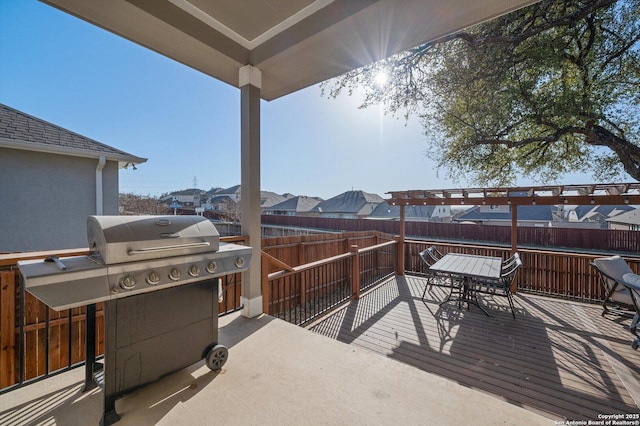 view of patio featuring grilling area, a fenced backyard, outdoor dining space, and a deck