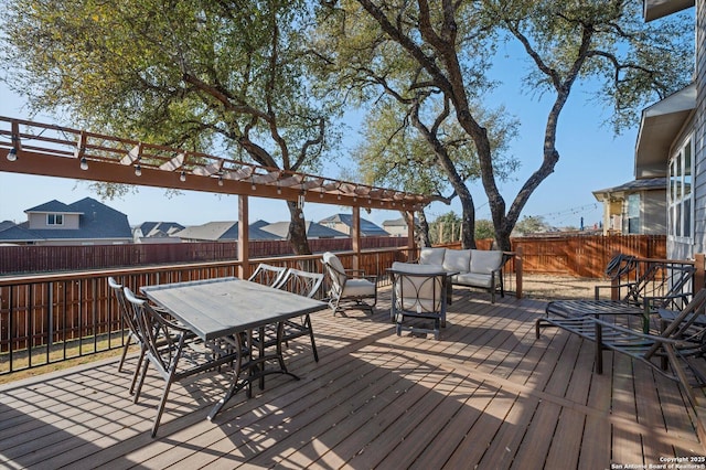 deck featuring outdoor dining space, a pergola, outdoor lounge area, and a fenced backyard