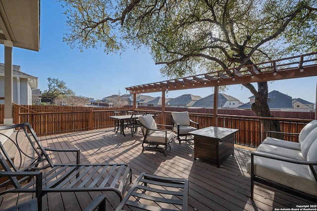 wooden deck with outdoor dining space and fence