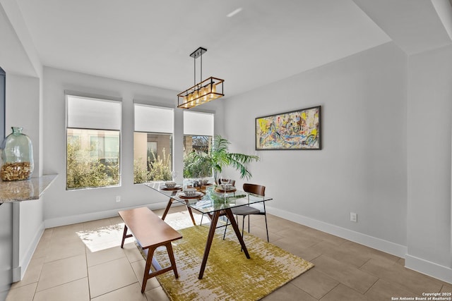 dining area with light tile patterned flooring and baseboards