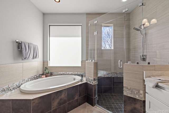 full bath featuring a garden tub and a shower stall