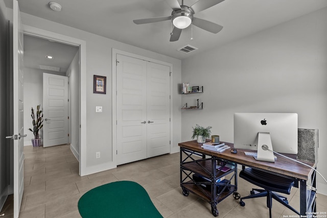 home office with light tile patterned floors, baseboards, visible vents, and ceiling fan