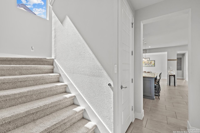 stairway featuring tile patterned flooring