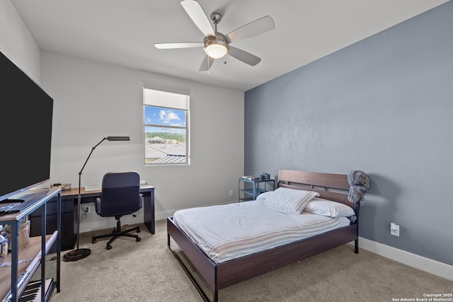 bedroom with ceiling fan, baseboards, and light carpet