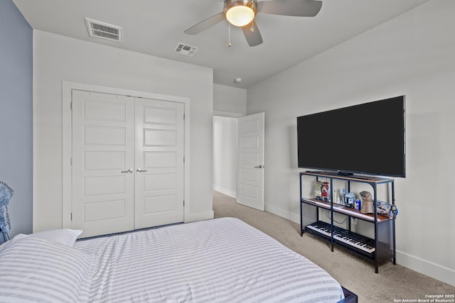 carpeted bedroom with baseboards, visible vents, a closet, and ceiling fan