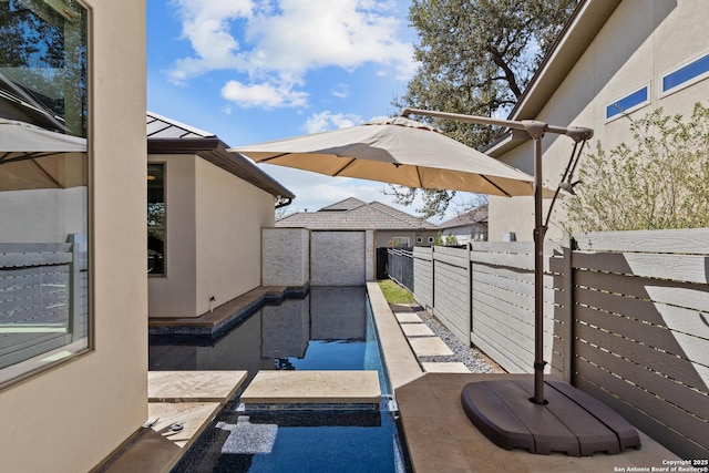 view of patio with a fenced backyard and a garage