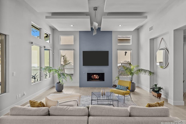 tiled living area featuring recessed lighting, visible vents, baseboards, and a fireplace