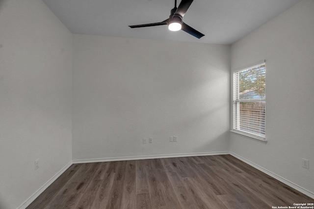 spare room with a ceiling fan, wood finished floors, and baseboards