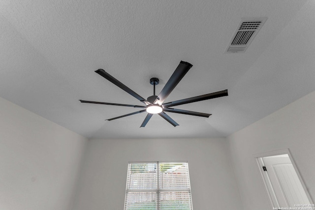 details featuring a ceiling fan, visible vents, and a textured ceiling