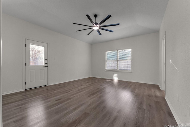 interior space with baseboards, a ceiling fan, and wood finished floors