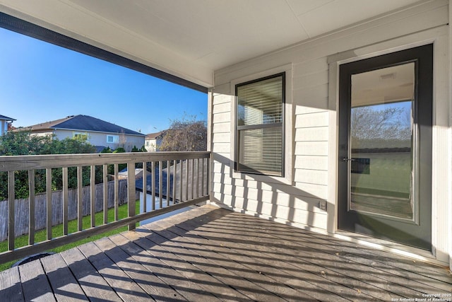 wooden terrace featuring fence