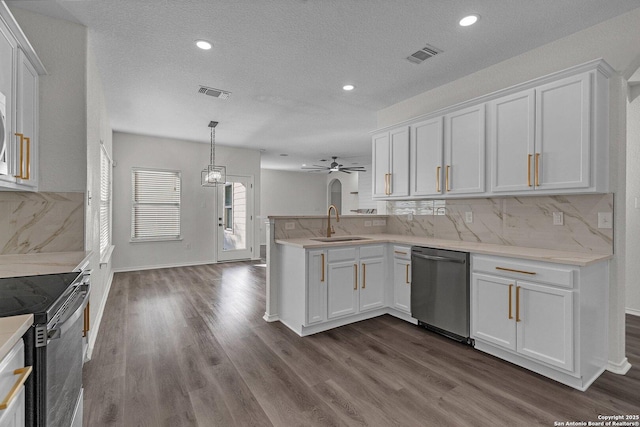 kitchen with visible vents, a peninsula, stainless steel dishwasher, white cabinetry, and a sink