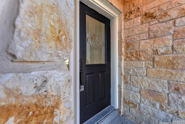 doorway to property featuring stone siding