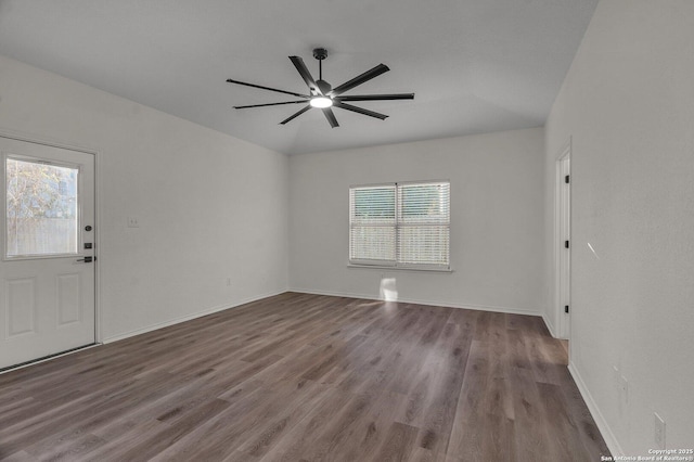 interior space with a ceiling fan, wood finished floors, a healthy amount of sunlight, and baseboards