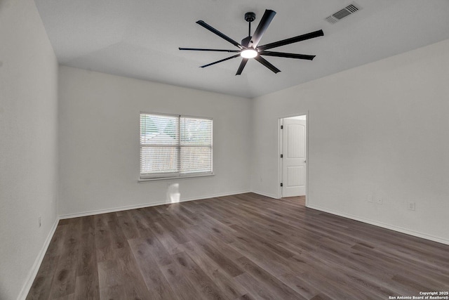 empty room featuring dark wood finished floors, visible vents, baseboards, and ceiling fan