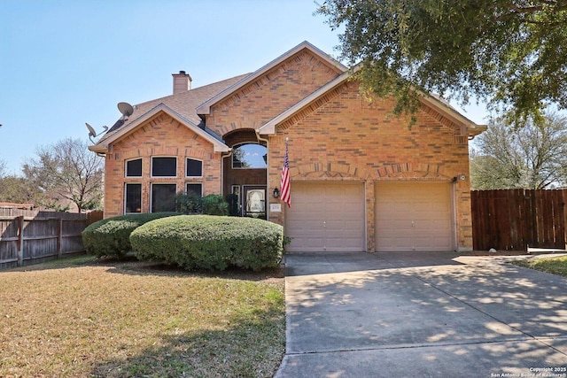 traditional-style house featuring brick siding, concrete driveway, a garage, and fence