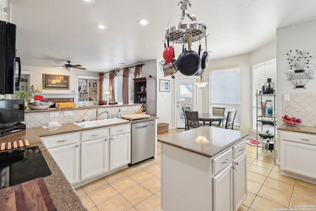 kitchen featuring a sink, decorative backsplash, white cabinets, dishwasher, and black electric cooktop